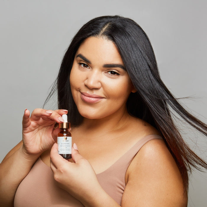 Woman holding Vivier serum bottle